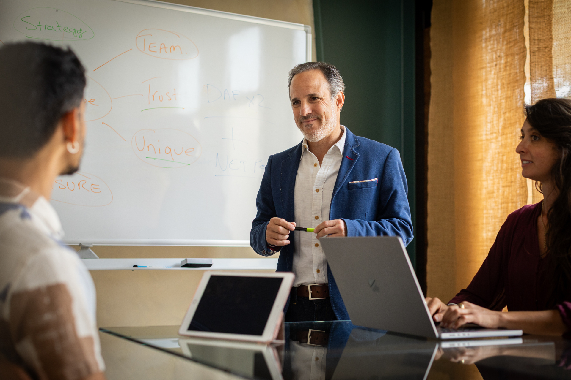 Simcha facilitating a strategy session at the whiteboard