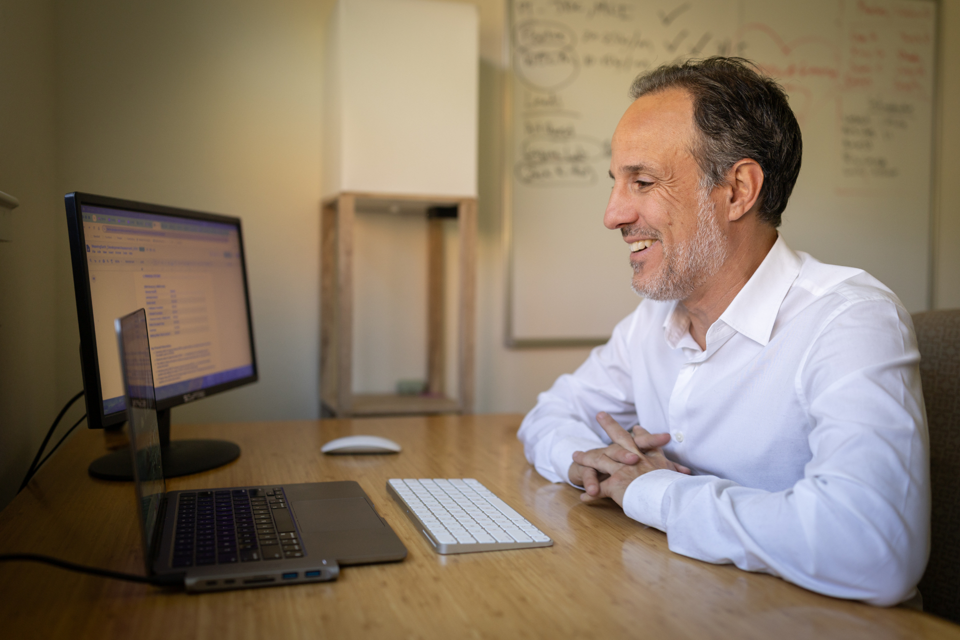 Simcha working at his desk with AI tools